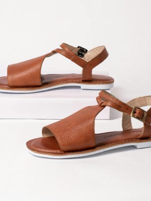 Set of elegant brown leather sandals displayed on a sleek white studio background.